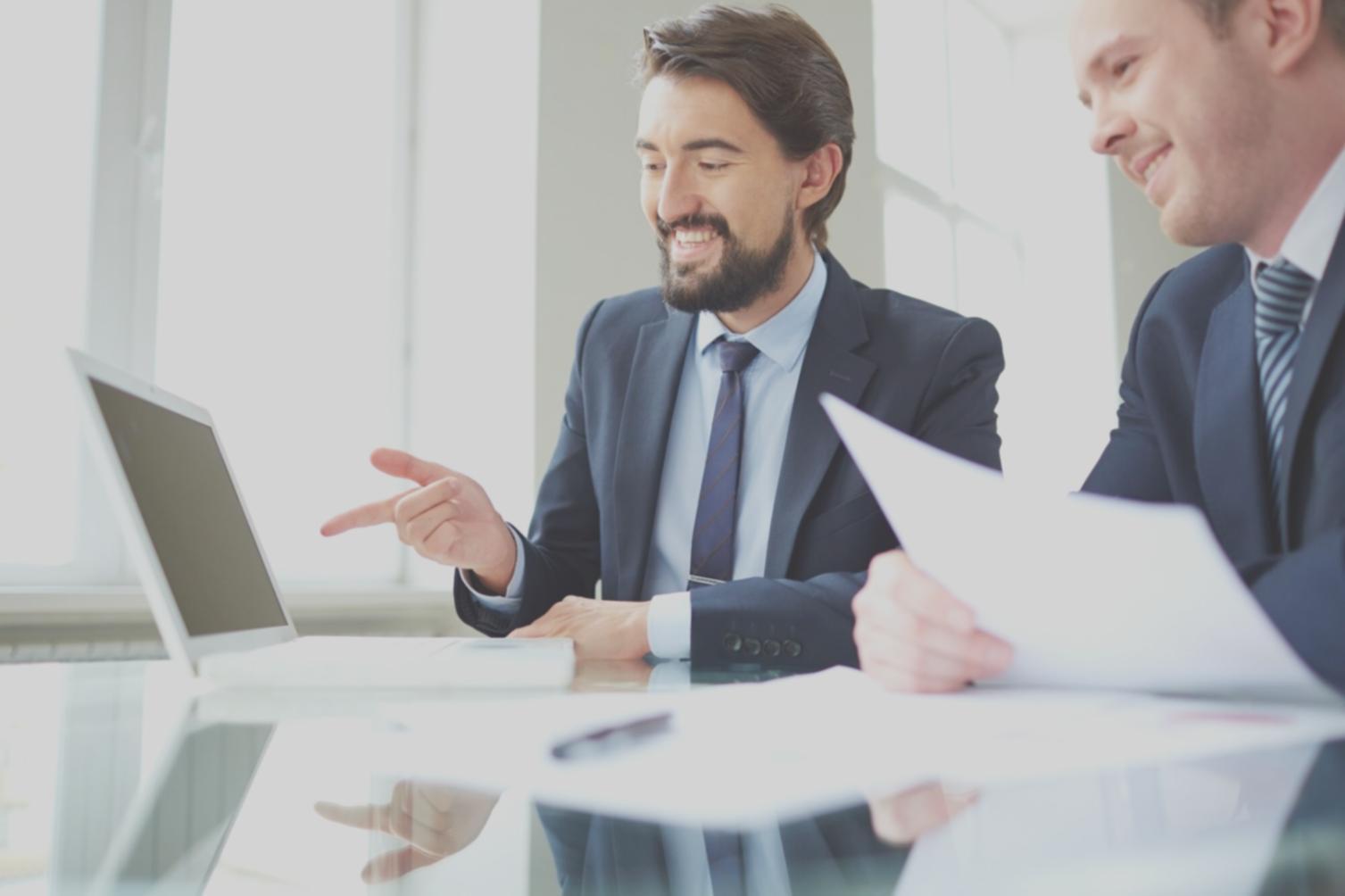 Business professionals collaborating on financial analysis in modern office setting